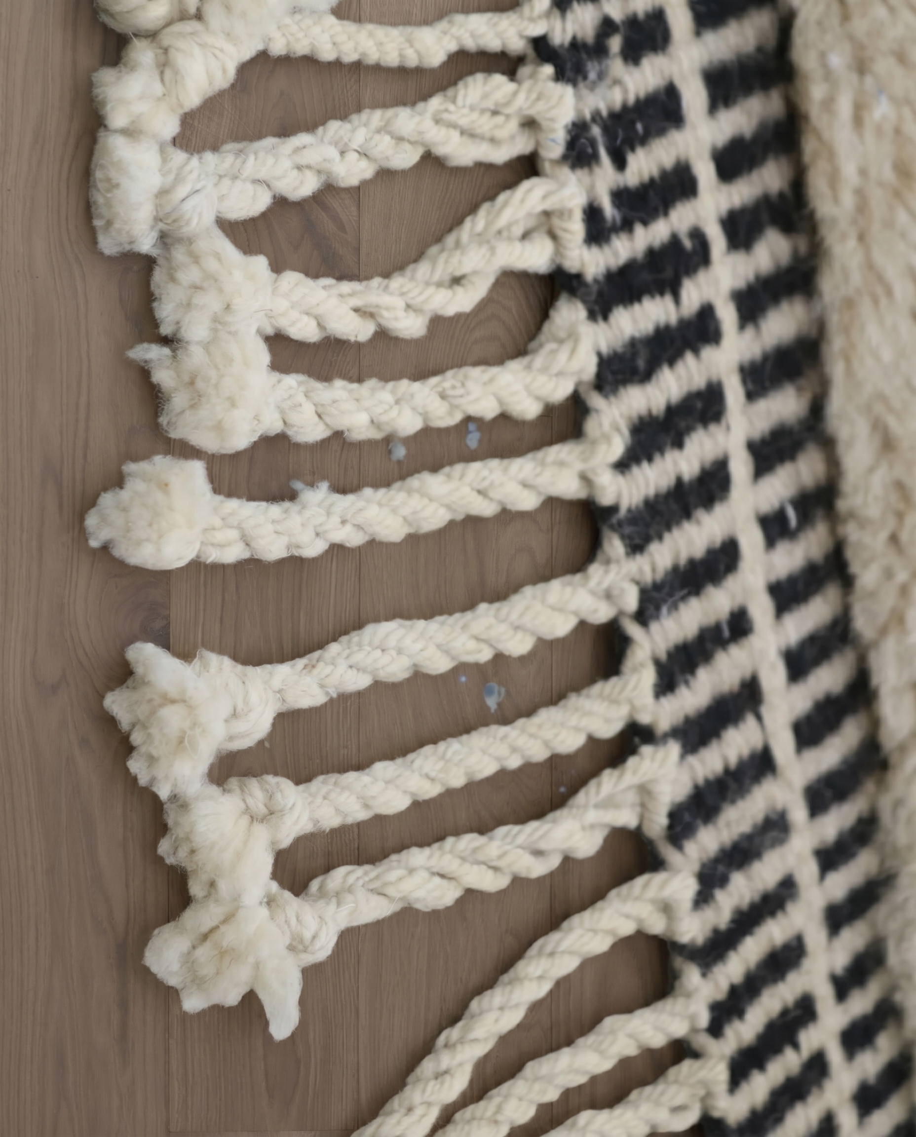 BINA Mrirt cream diamond lattice Moroccan rug close-up of hand-tied fringe and kilim band detail, by NURA