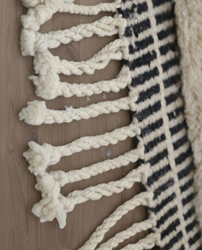 BINA Mrirt cream diamond lattice Moroccan rug close-up of hand-tied fringe and kilim band detail, by NURA