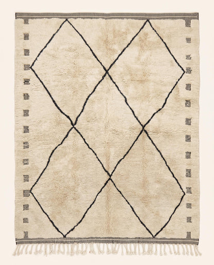 A plush cream Mrirt Moroccan rug featuring a minimalist black diamond lattice pattern, hand-knotted in wool by NURA.