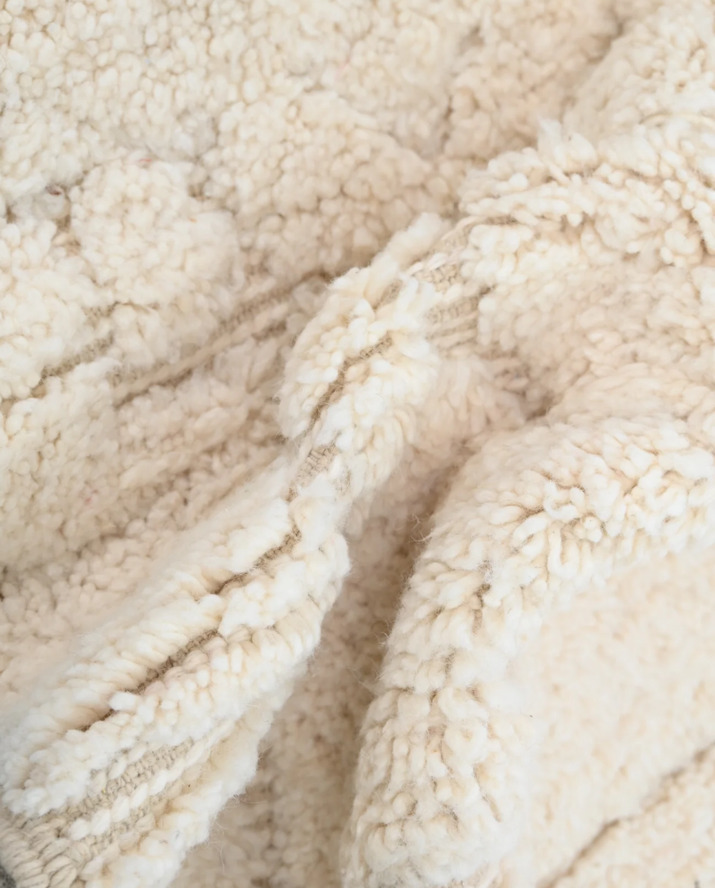 BOUTHAINA Beni Ourain cream organic abstract Moroccan rug close-up showing hand-knotted wool texture and pile detail 2, by NURA