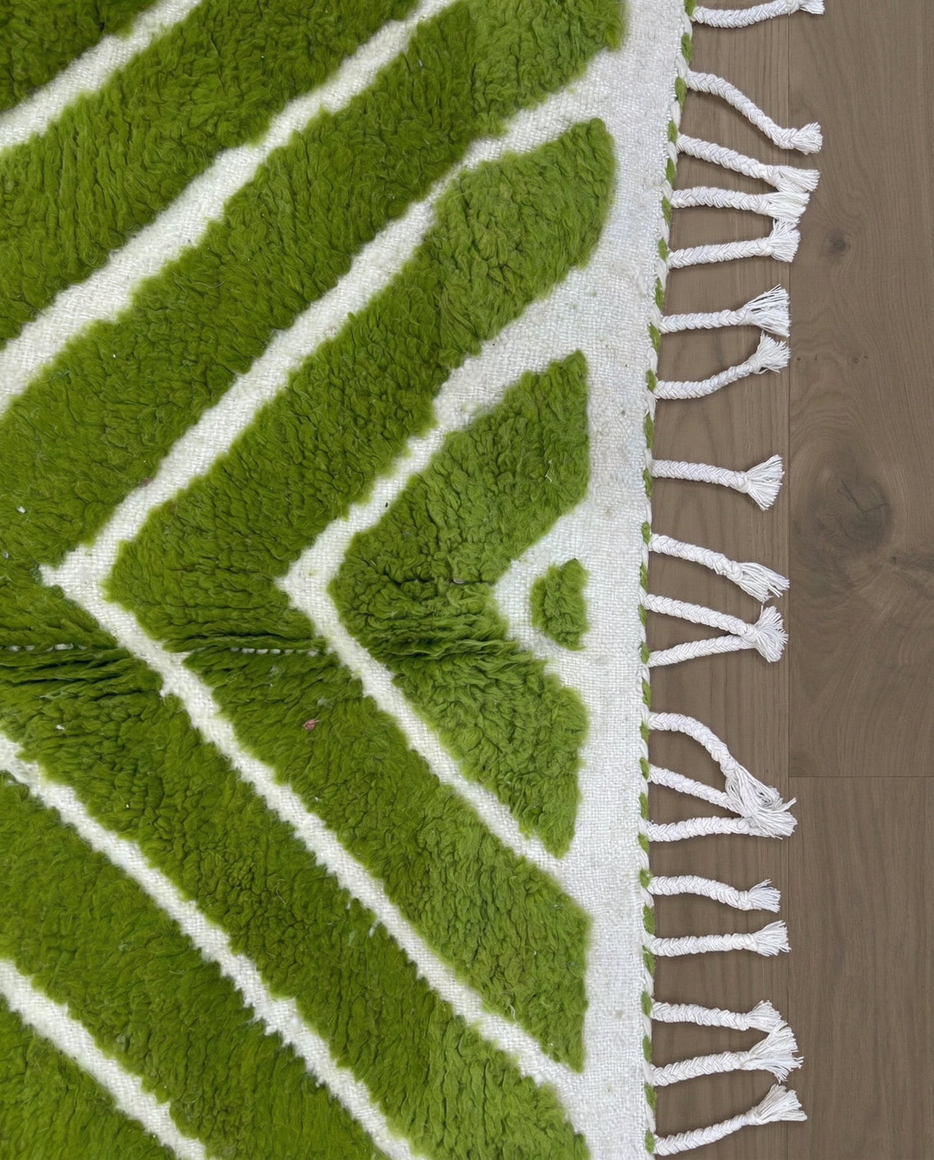LAMIA Beni Ourain green chevron stripes Moroccan rug close-up of hand-tied fringe and kilim band detail, by NURA