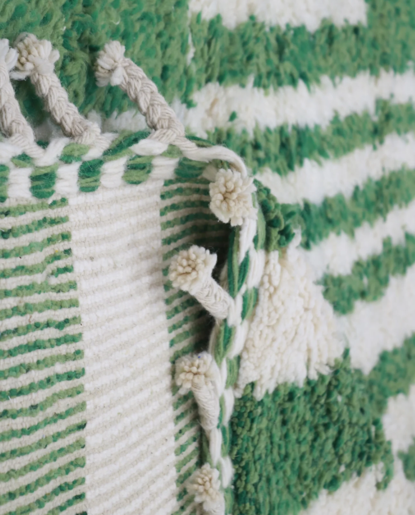 DANA Azilal green color block Moroccan rug close-up of hand-tied fringe and kilim band detail, by NURA