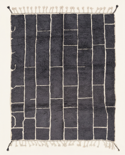 Plush charcoal Beni Ourain Moroccan rug with a bold ivory irregular block grid and a thick high pile, by NURA.