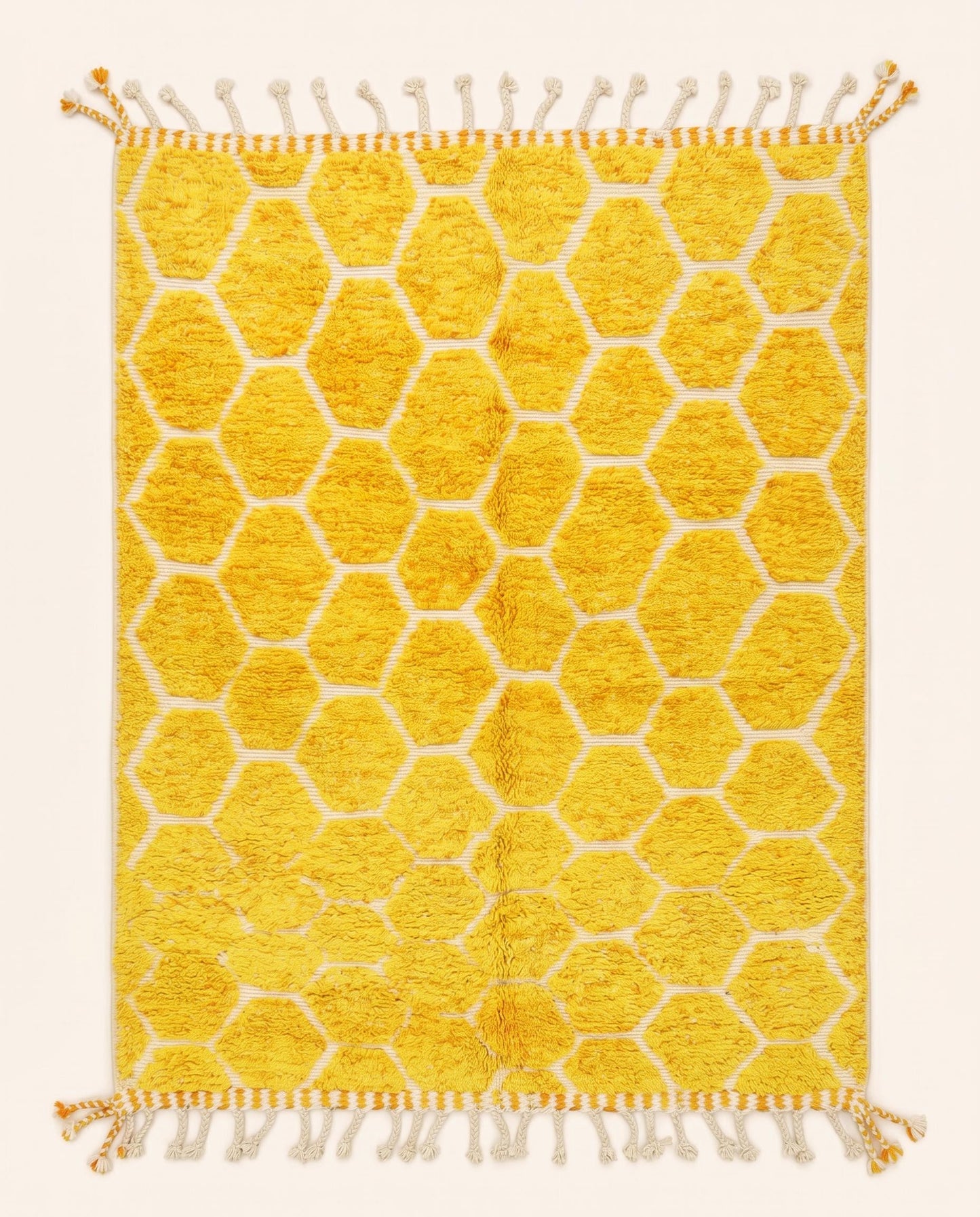 A vibrant Azilal Moroccan rug featuring a plush mustard yellow honeycomb pattern on a flatwoven cream grid, crafted by NURA.