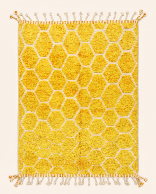 A vibrant Azilal Moroccan rug featuring a plush mustard yellow honeycomb pattern on a flatwoven cream grid, crafted by NURA.