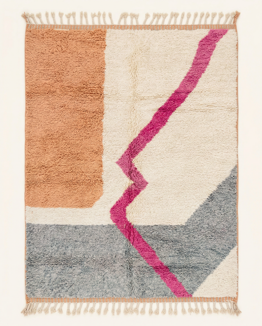 Plush cream Azilal Moroccan rug with abstract color blocks in grey and peach and a bold magenta zigzag line, by NURA.