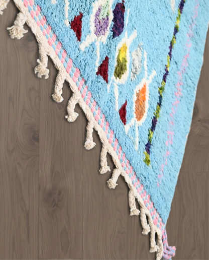 FADDA Azilal sky blue floating forms Moroccan rug close-up of hand-tied fringe and kilim band detail, by NURA
