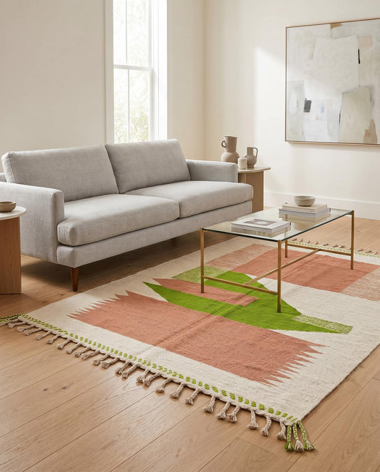 A vibrant Moroccan flatweave rug with terracotta and green color blocks styled in a modern living room by NURA.