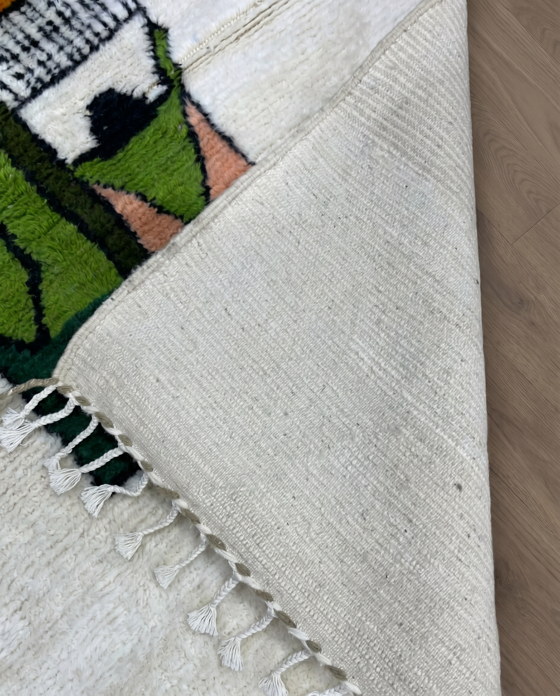 FADWA Azilal ivory abstract figurative motif Moroccan rug back view showing traditional handwoven construction, by NURA