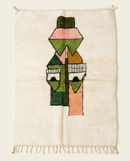Plush ivory Azilal Moroccan rug featuring a bold, playful abstract face motif in green, peach, and pink, with a thick high pile, by NURA.