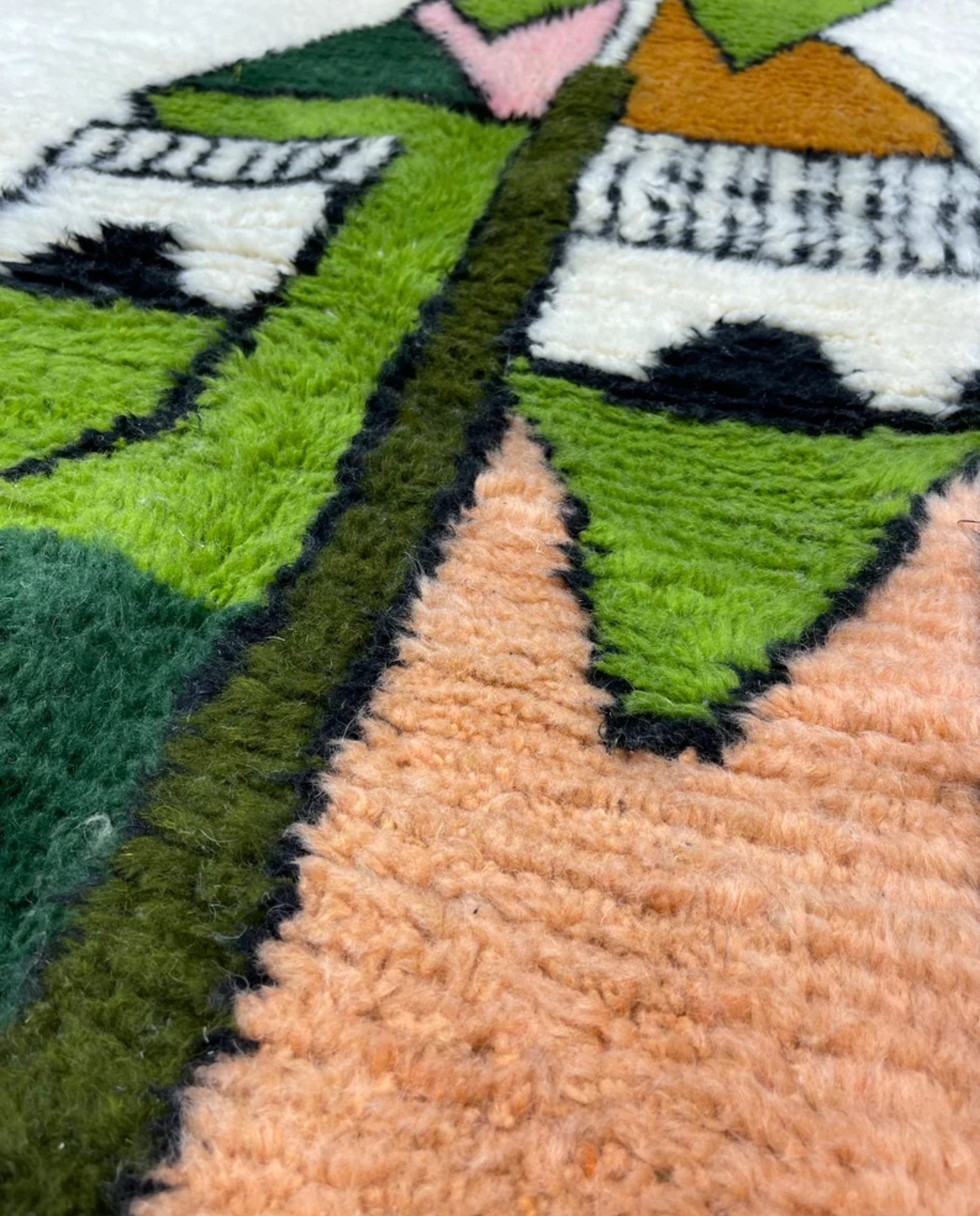 FADWA Azilal ivory abstract figurative motif Moroccan rug close-up showing hand-knotted wool texture and pile detail, by NURA