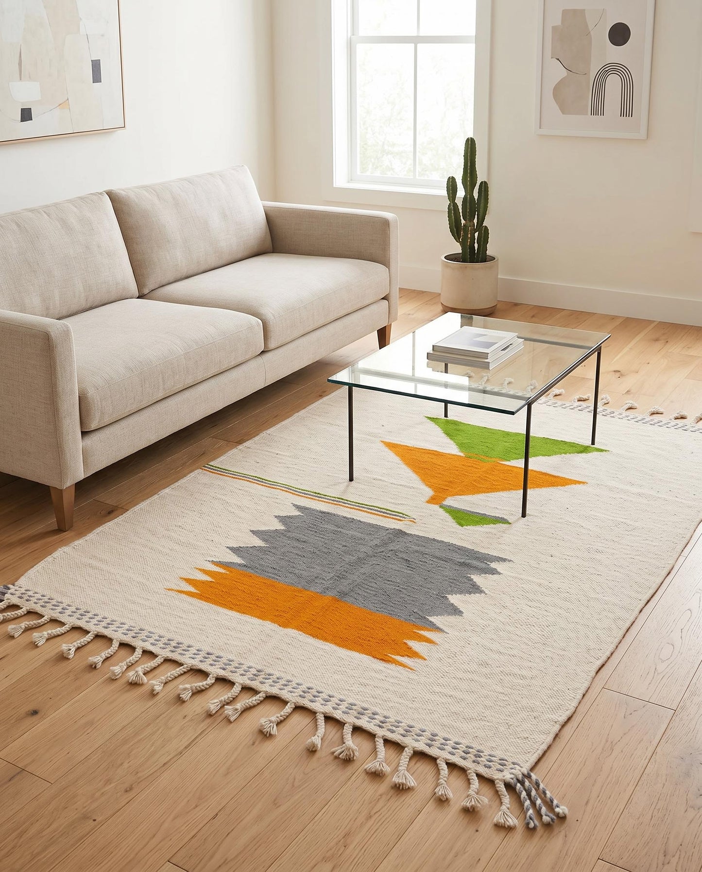 A vibrant flatwoven Moroccan kilim rug with orange and grey color blocks styled in a bright, contemporary living room by NURA.