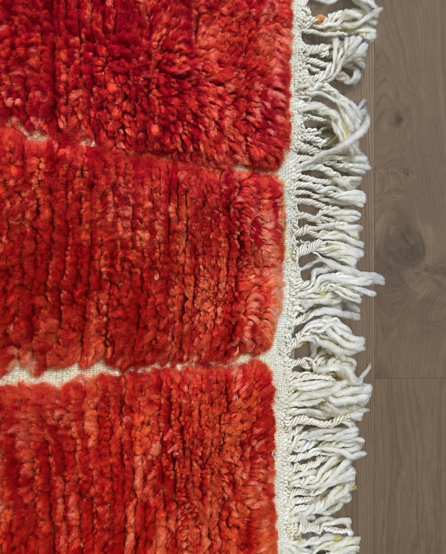 FATIMA Beni Ourain crimson organic abstract Moroccan rug close-up of hand-tied fringe and kilim band detail, by NURA