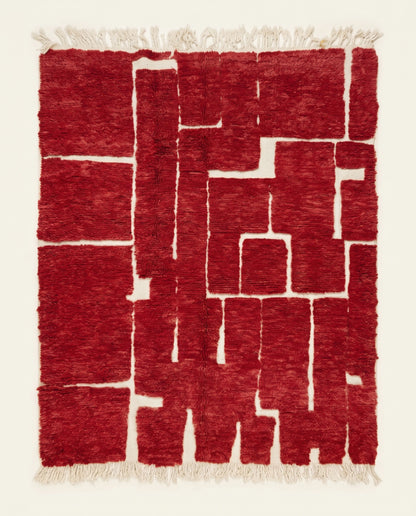 A striking red Moroccan rug by NURA featuring an organic abstract pattern of plush crimson blocks and recessed cream lines.