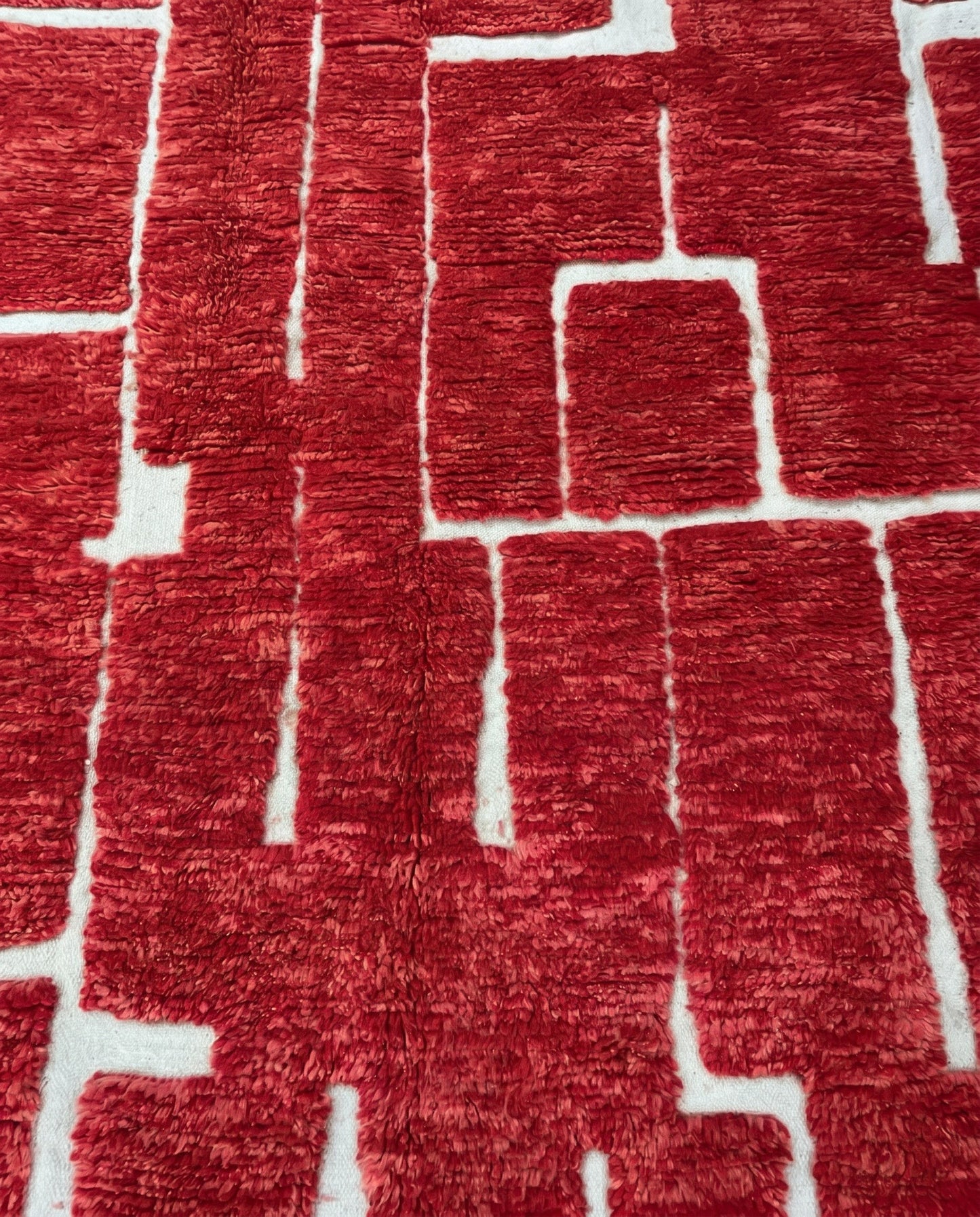 FATIMA Beni Ourain crimson organic abstract Moroccan rug close-up showing hand-knotted wool texture and pile detail, by NURA
