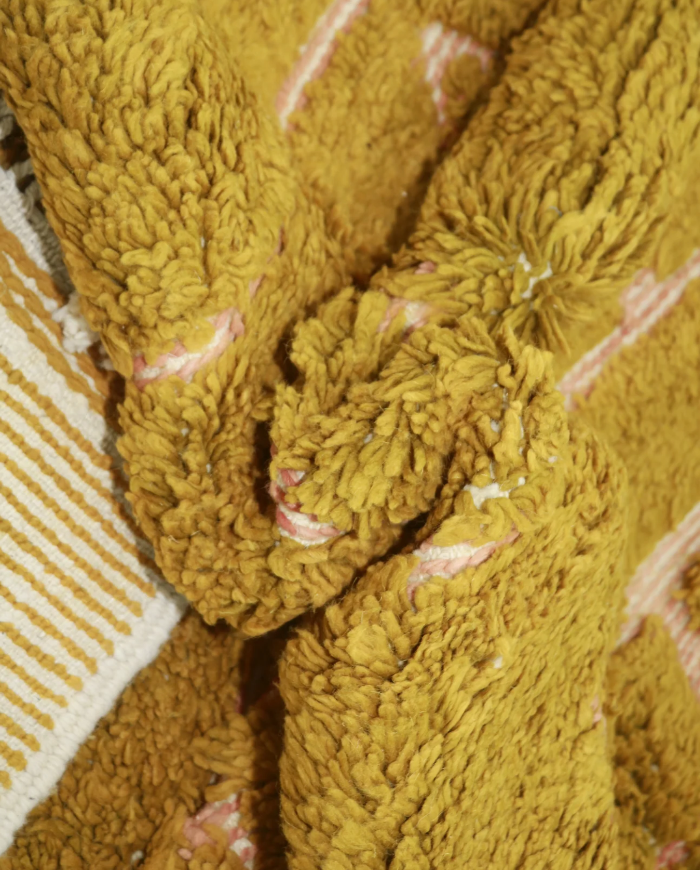 FAWZIA Azilal mustard organic abstract Moroccan rug close-up showing hand-knotted wool texture and pile detail, by NURA