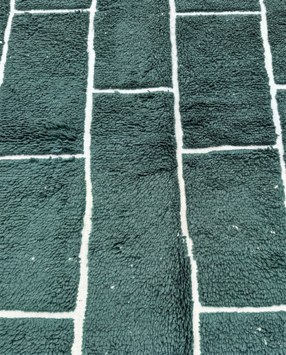 FIDA Beni Ourain forest green checker grid Moroccan rug close-up showing hand-knotted wool texture and pile detail, by NURA