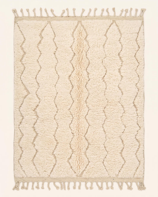 A plush cream Moroccan rug featuring a subtle carved diamond lattice pattern in natural wool, crafted by NURA.