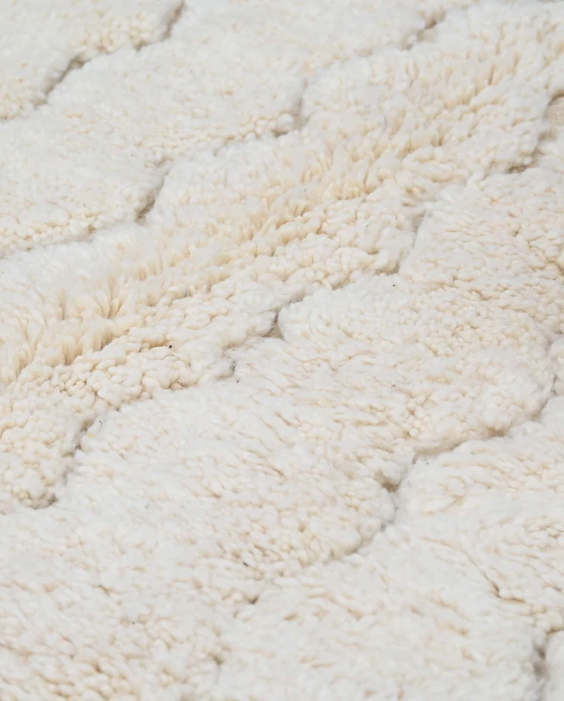 GHAZALA Beni Ourain cream diamond lattice Moroccan rug close-up showing hand-knotted wool texture and pile detail 1, by NURA