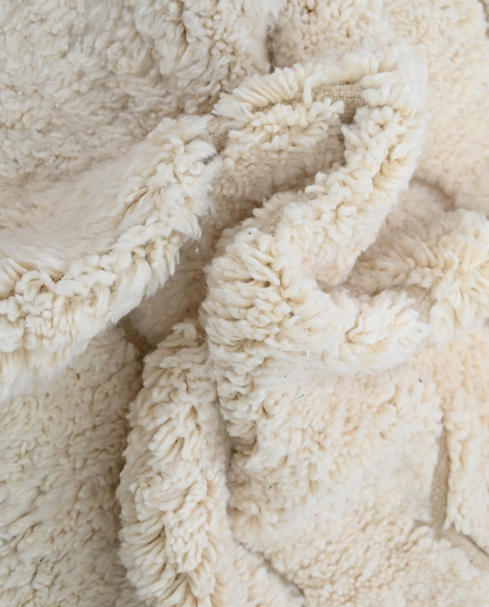 GHAZALA Beni Ourain cream diamond lattice Moroccan rug close-up showing hand-knotted wool texture and pile detail 2, by NURA