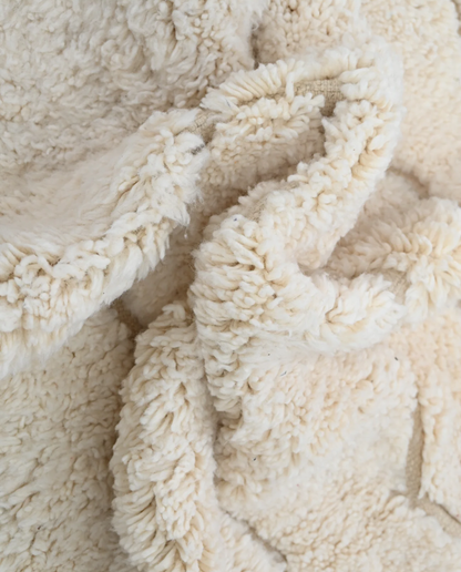 GHAZALA Beni Ourain cream diamond lattice Moroccan rug close-up showing hand-knotted wool texture and pile detail 2, by NURA