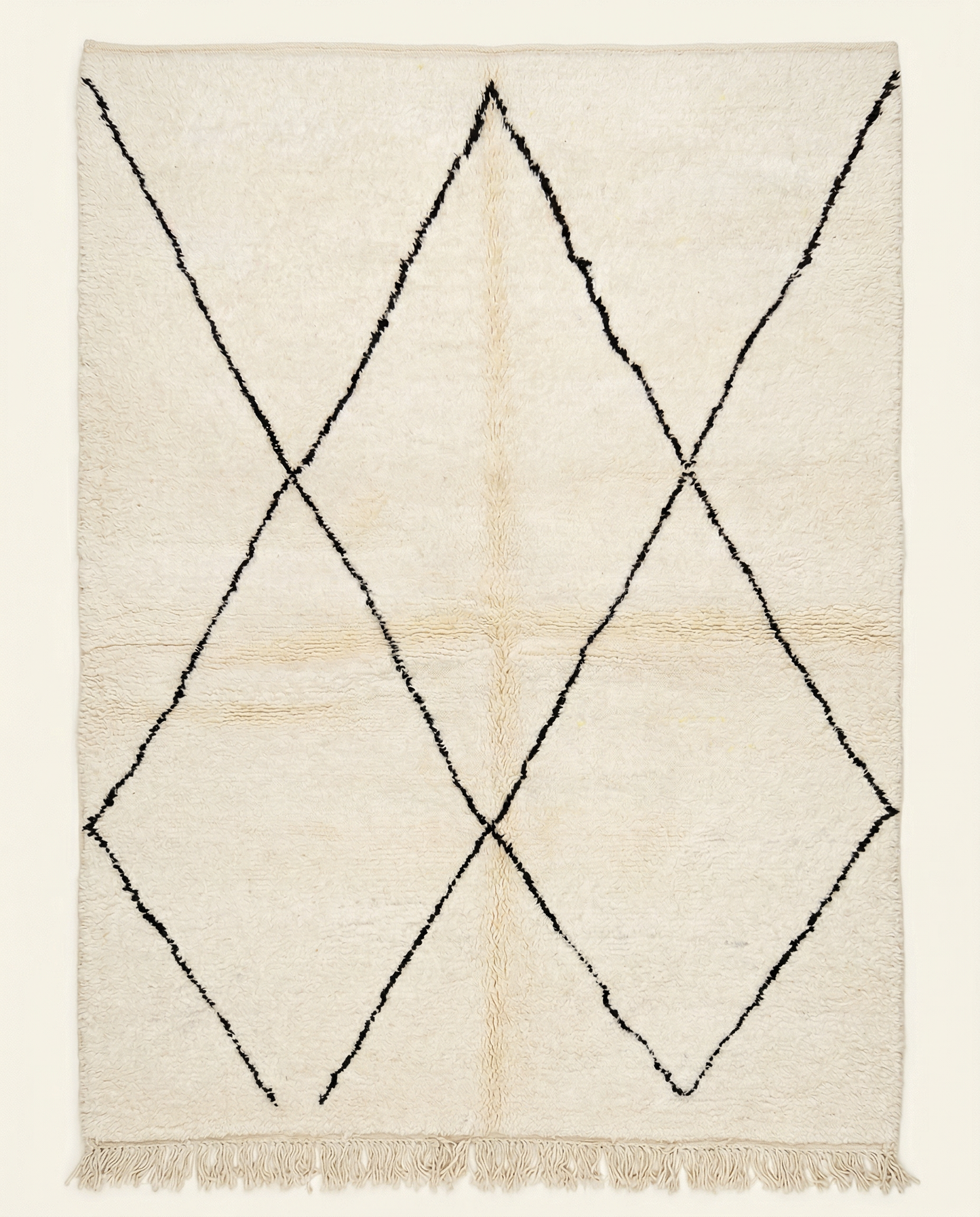 Plush ivory Beni Ourain Moroccan rug with a large-scale black diamond lattice and a thick high pile, by NURA.