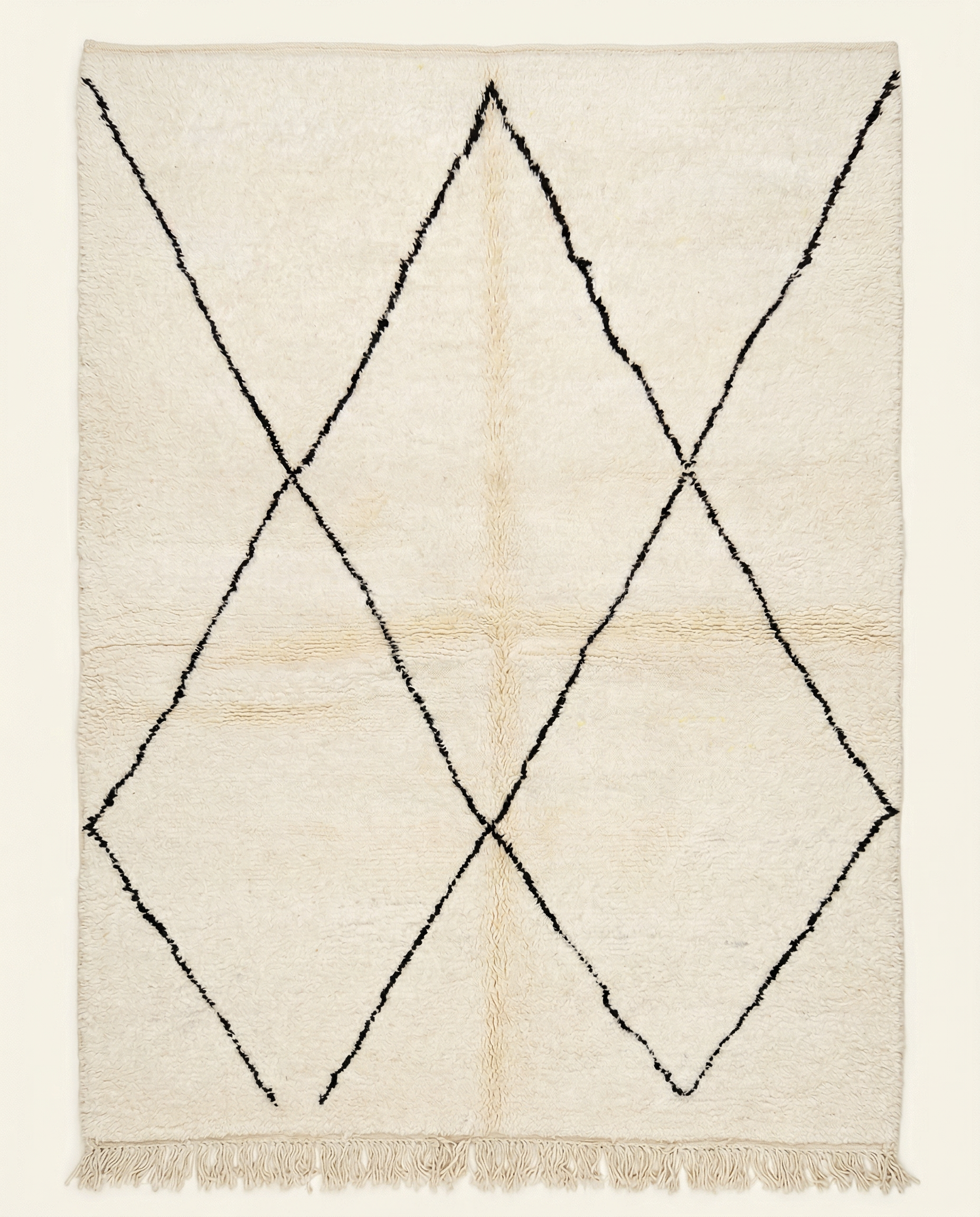 Plush ivory Beni Ourain Moroccan rug with a large-scale black diamond lattice and a thick high pile, by NURA.