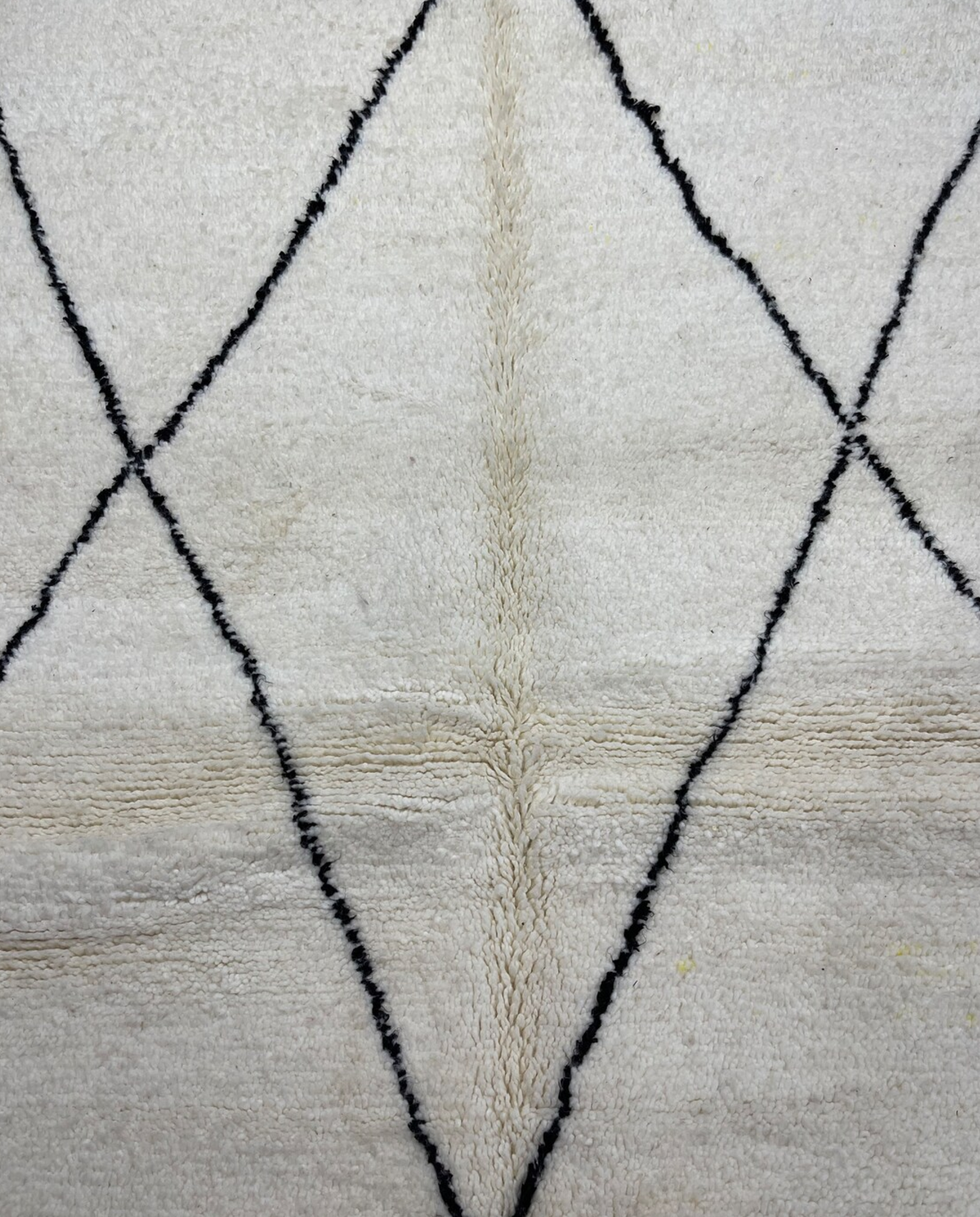 GHITA Beni Ourain ivory diamond lattice Moroccan rug close-up showing hand-knotted wool texture and pile detail, by NURA