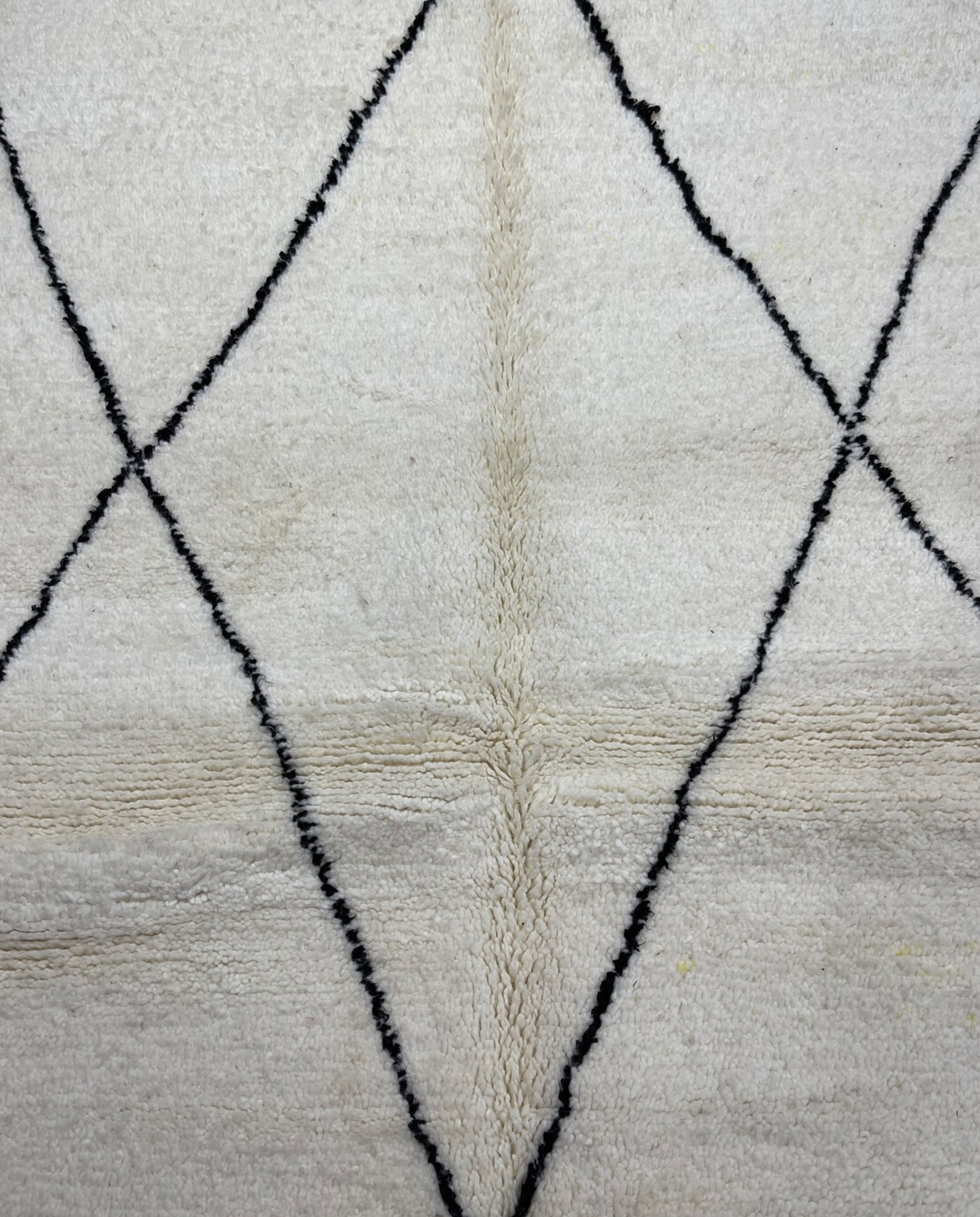 GHITA Beni Ourain ivory diamond lattice Moroccan rug close-up showing hand-knotted wool texture and pile detail, by NURA