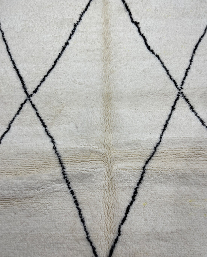 GHITA Beni Ourain ivory diamond lattice Moroccan rug close-up showing hand-knotted wool texture and pile detail, by NURA