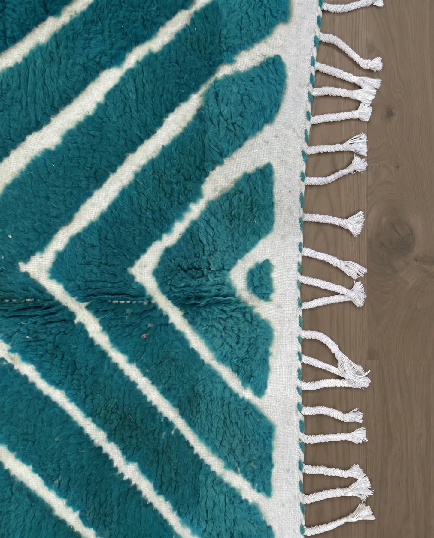 HAFIDA Beni Ourain teal chevron stripes Moroccan rug close-up of hand-tied fringe and kilim band detail, by NURA