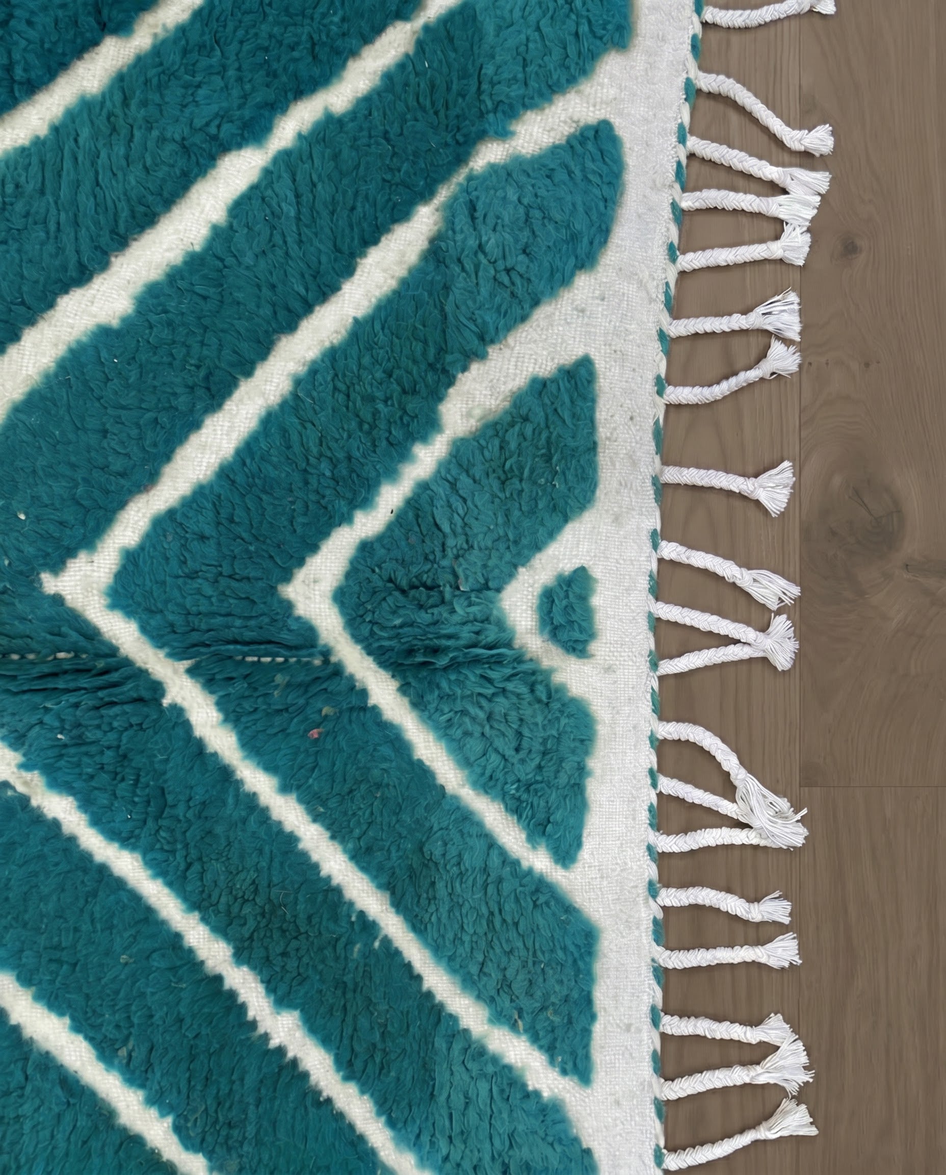 HAFIDA Beni Ourain teal chevron stripes Moroccan rug close-up of hand-tied fringe and kilim band detail, by NURA