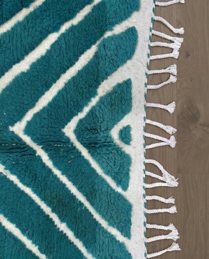HAFIDA Beni Ourain teal chevron stripes Moroccan rug close-up of hand-tied fringe and kilim band detail, by NURA