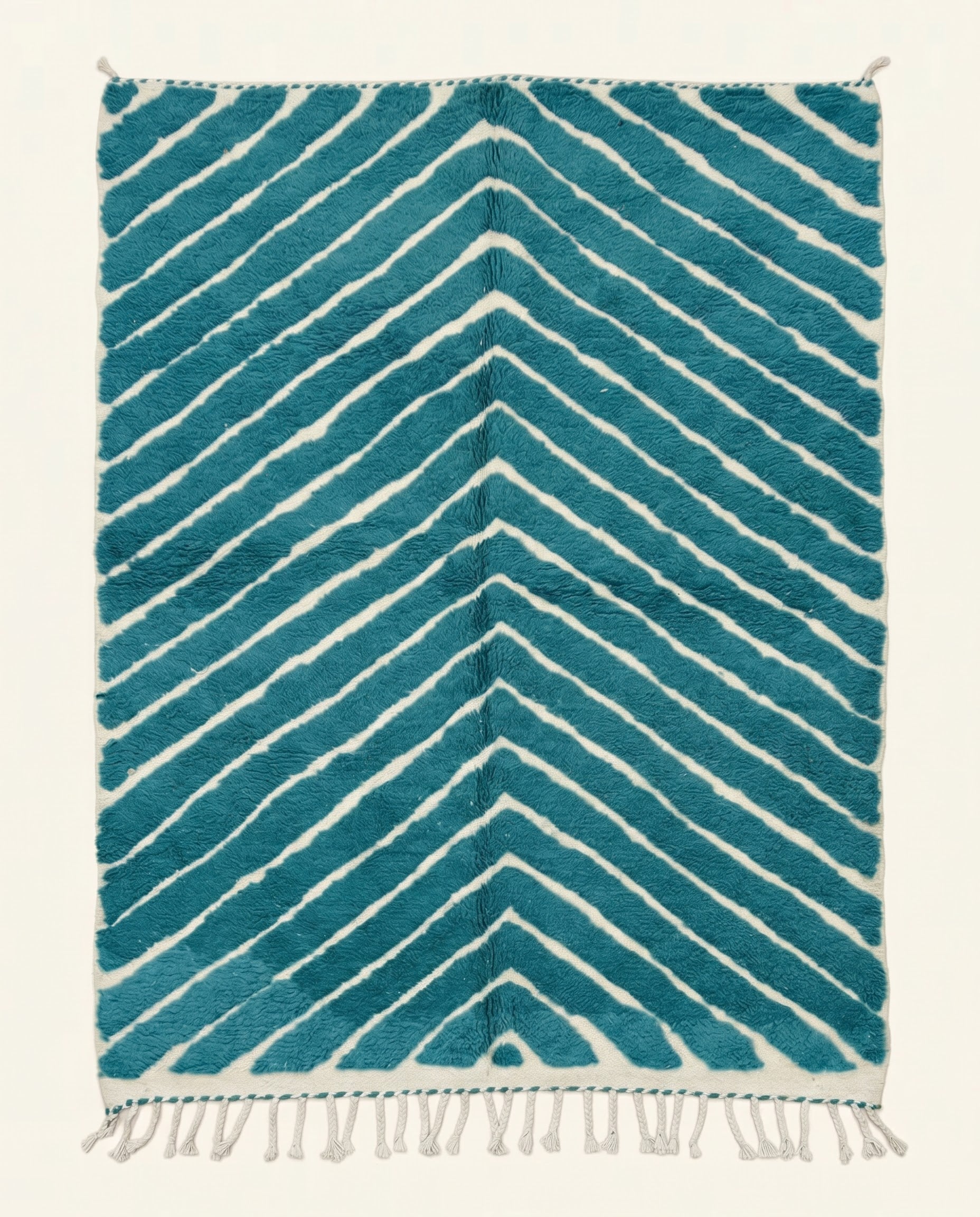 A plush Moroccan Beni Ourain rug featuring bold cream chevron stripes on a rich teal background, custom made by NURA.