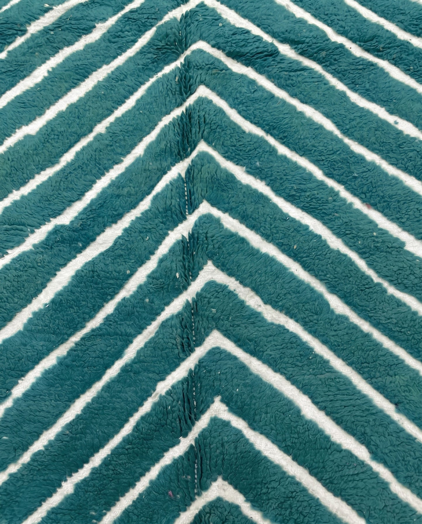 HAFIDA Beni Ourain teal chevron stripes Moroccan rug close-up showing hand-knotted wool texture and pile detail, by NURA