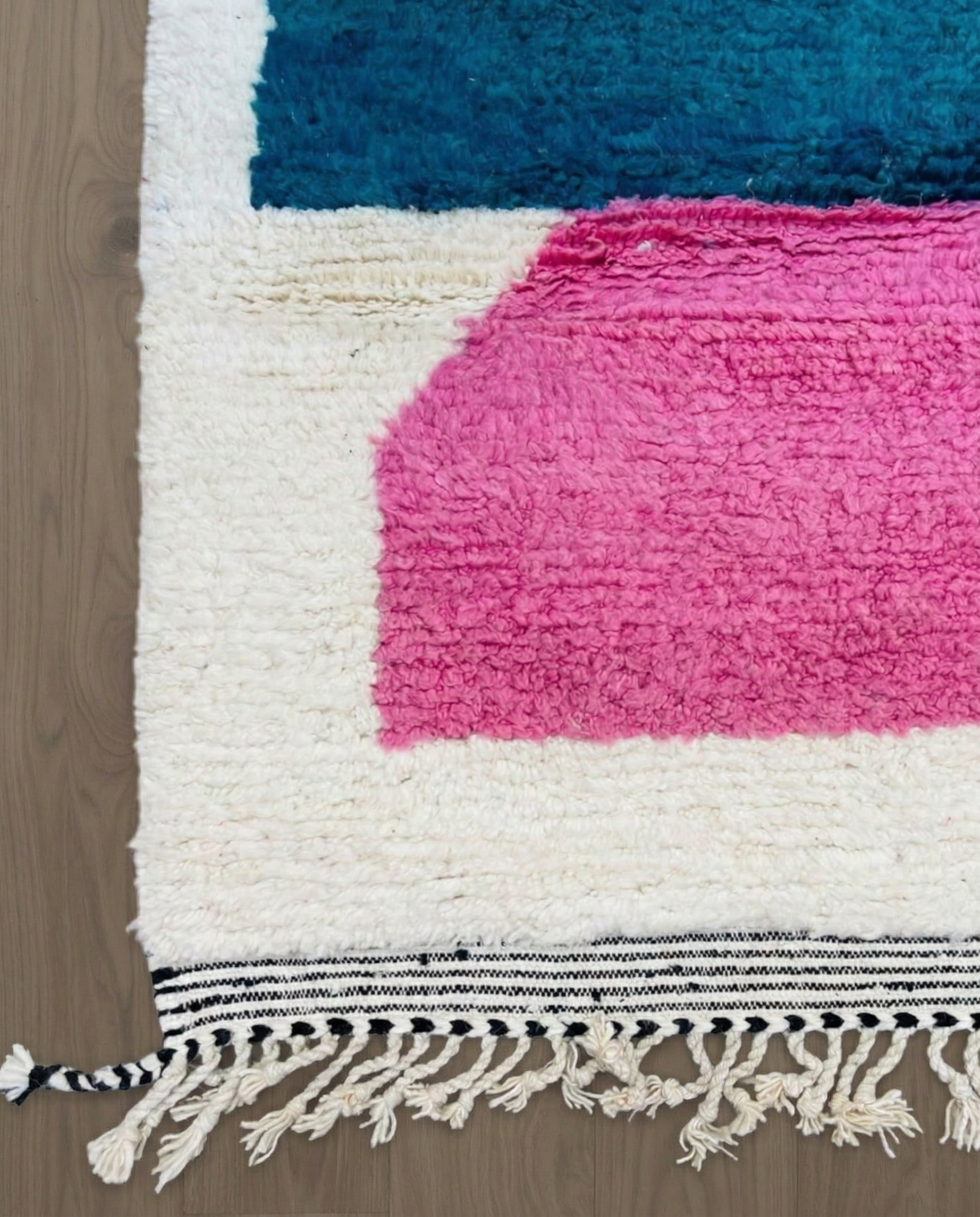 HAFSA Beni Ourain ivory abstract color block Moroccan rug close-up of hand-tied fringe and kilim band detail, by NURA