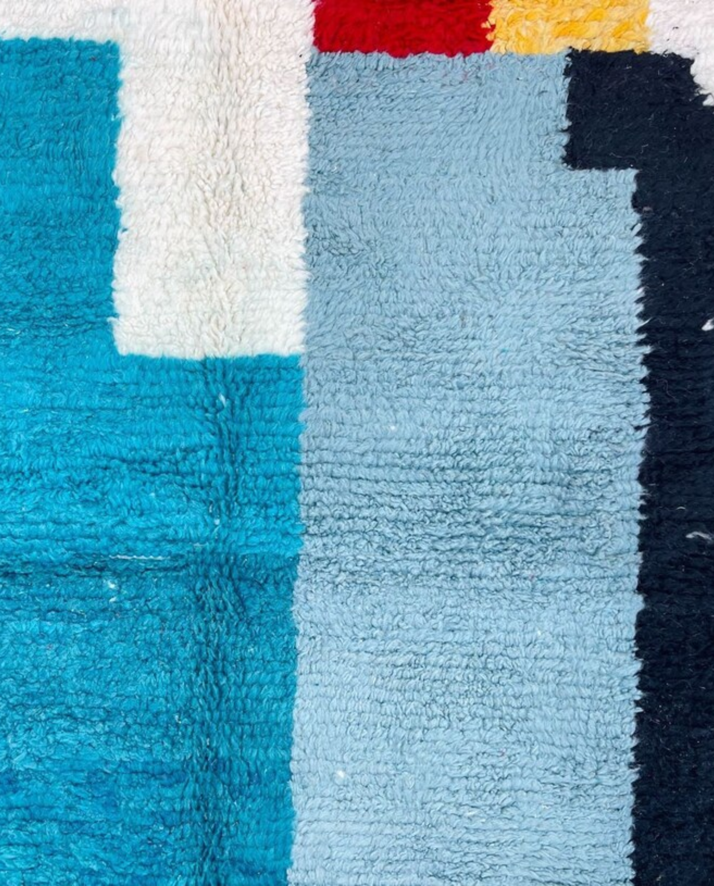 HAFSA Beni Ourain ivory abstract color block Moroccan rug close-up showing hand-knotted wool texture and pile detail 1, by NURA
