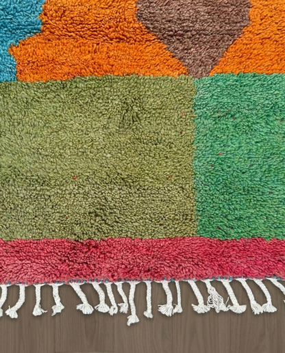 HANAE Beni Ourain orange abstract color block Moroccan rug close-up of hand-tied fringe and kilim band detail, by NURA