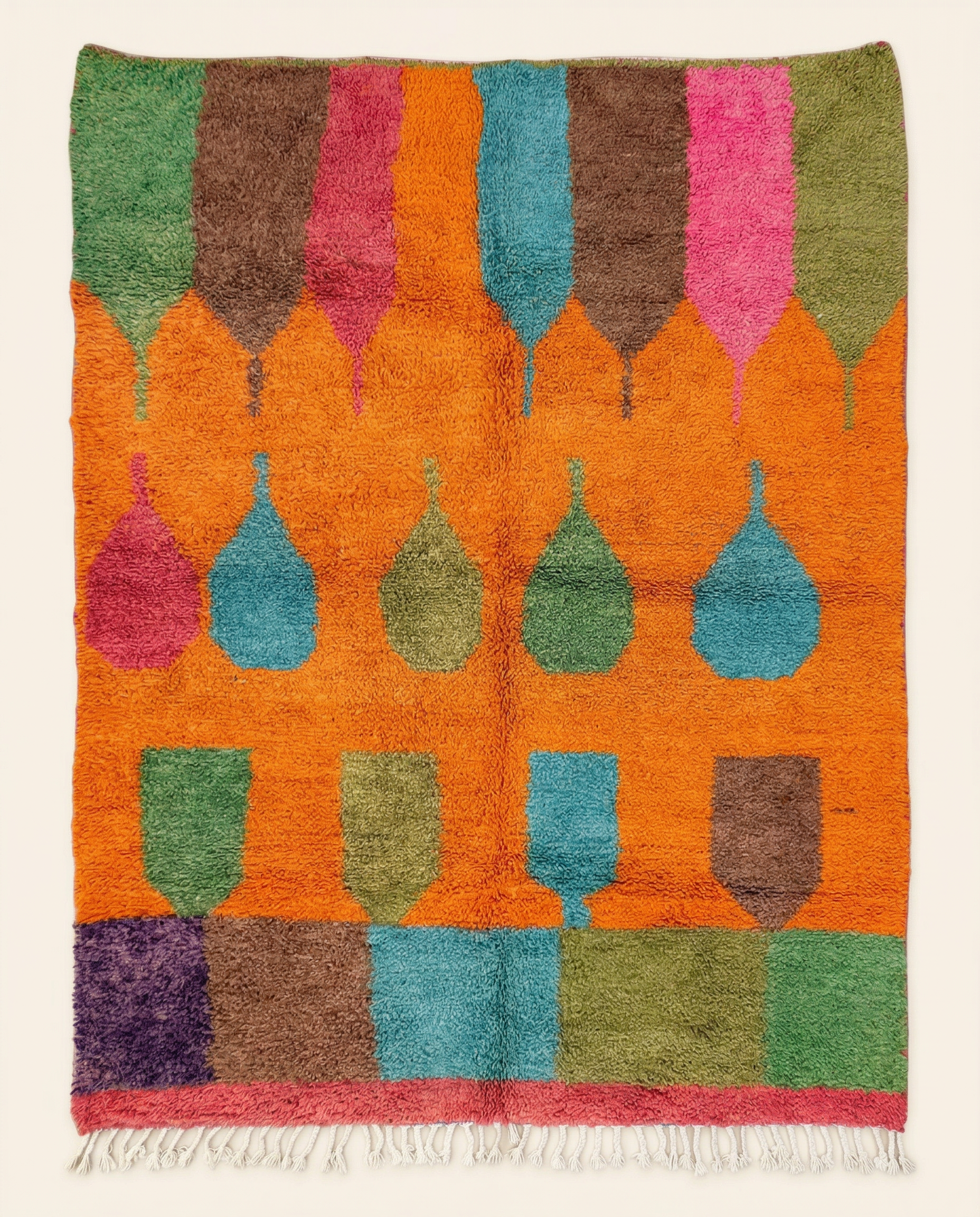 Plush orange Moroccan rug with floating abstract vessel motifs and a wide multicolored block border, by NURA.