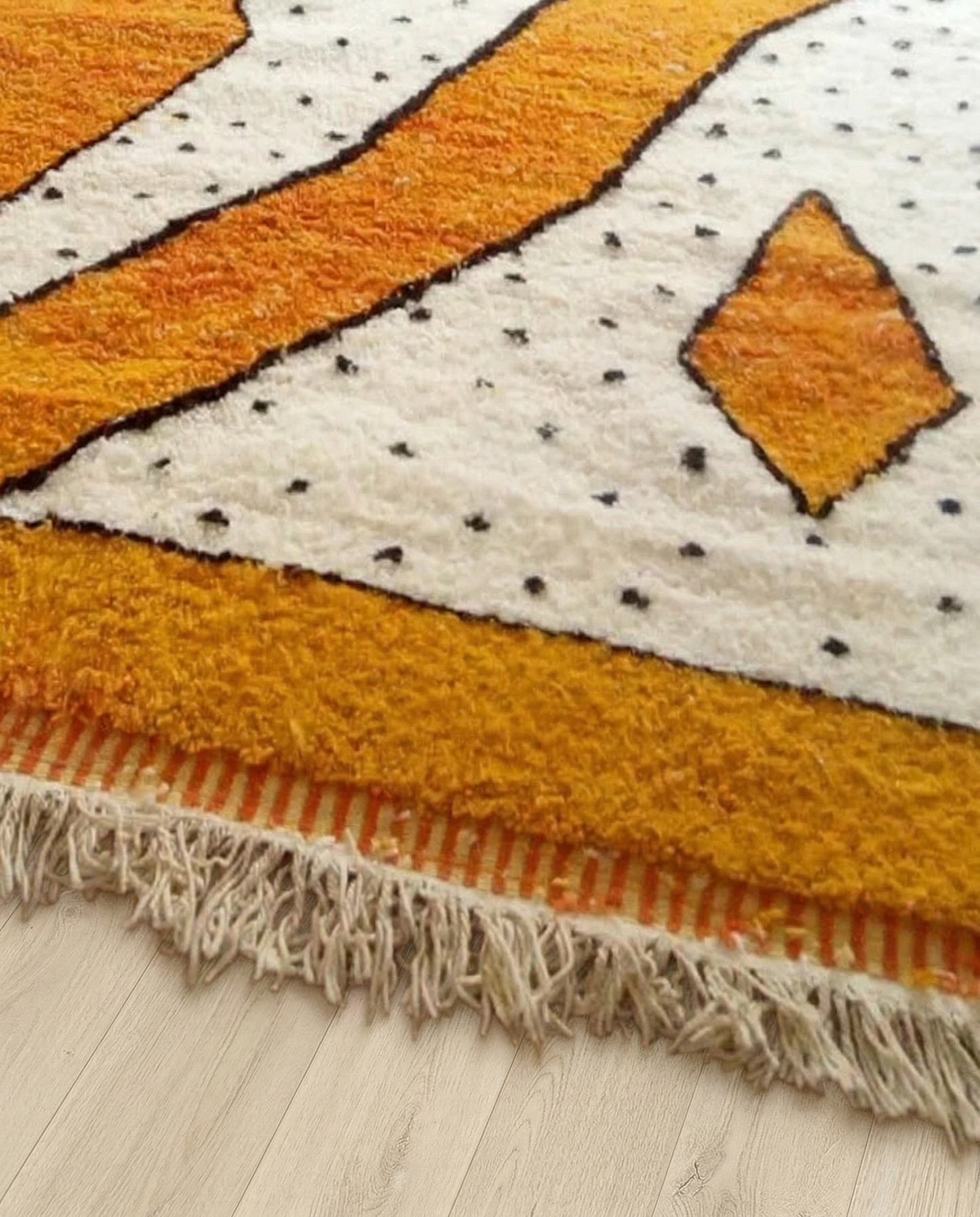HIBA Mrirt cream bold abstract field Moroccan rug close-up of hand-tied fringe and kilim band detail, by NURA
