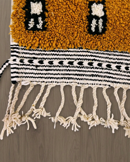HOUDA Beni Ourain mustard banded geometric field Moroccan rug close-up of hand-tied fringe and kilim band detail, by NURA