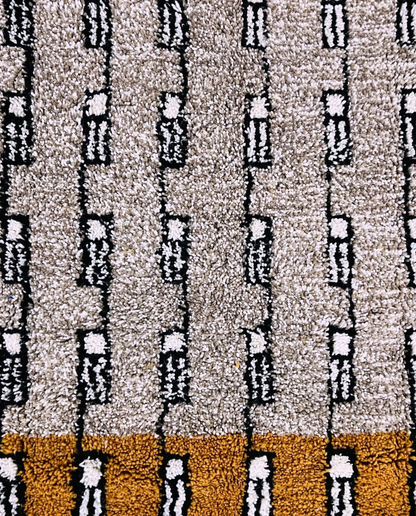 HOUDA Beni Ourain mustard banded geometric field Moroccan rug close-up showing hand-knotted wool texture and pile detail 1, by NURA
