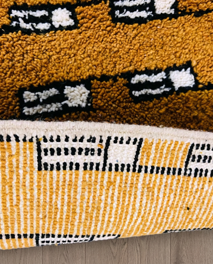 HOUDA Beni Ourain mustard banded geometric field Moroccan rug close-up showing hand-knotted wool texture and pile detail 3, by NURA