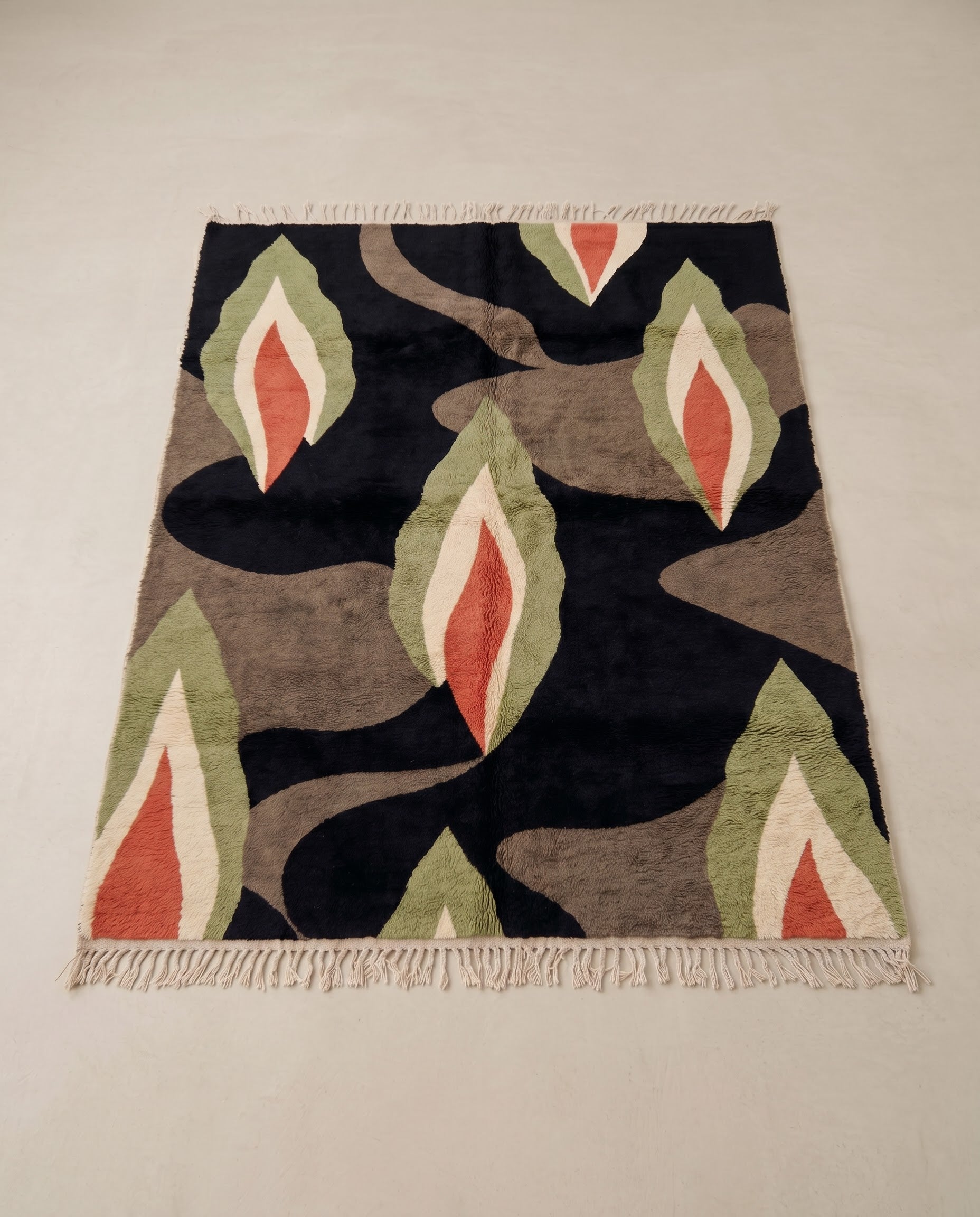 HOURIA Mrirt black organic abstract Moroccan rug displayed on a parquet wood floor, showing full fringe and edge detail, by NURA