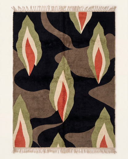 A plush Moroccan wool rug with a bold organic abstract pattern of sage, rust, and cream shapes on a black background by NURA.