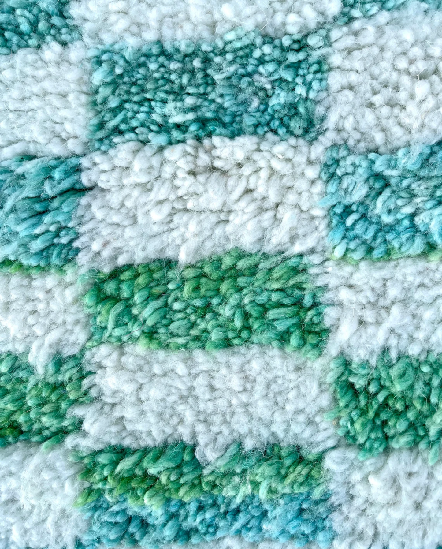 IBTISSAM Beni Ourain teal checker grid Moroccan rug close-up showing hand-knotted wool texture and pile detail, by NURA