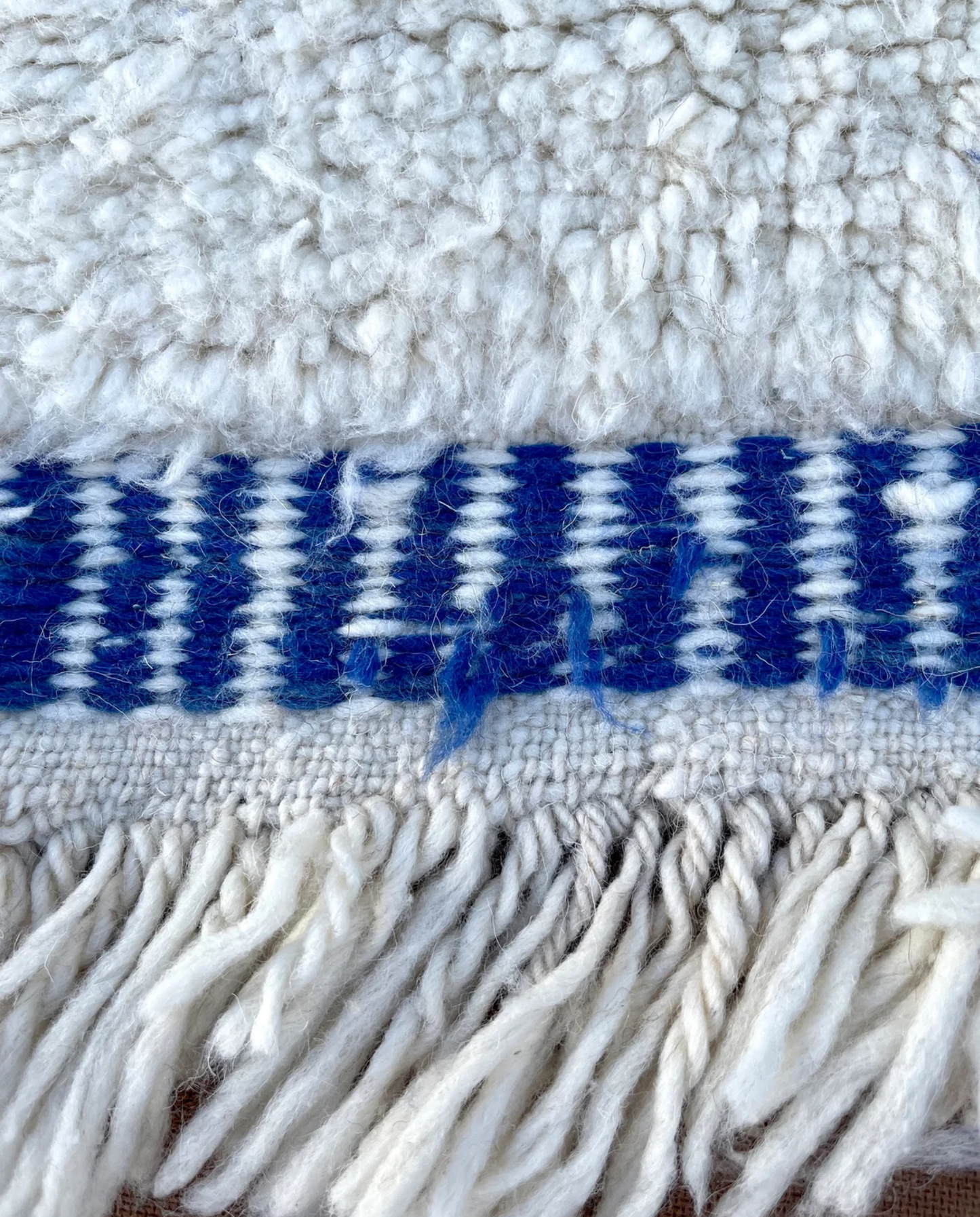 IHSANE Beni Ourain cobalt bold color block Moroccan rug close-up of hand-tied fringe and kilim band detail, by NURA
