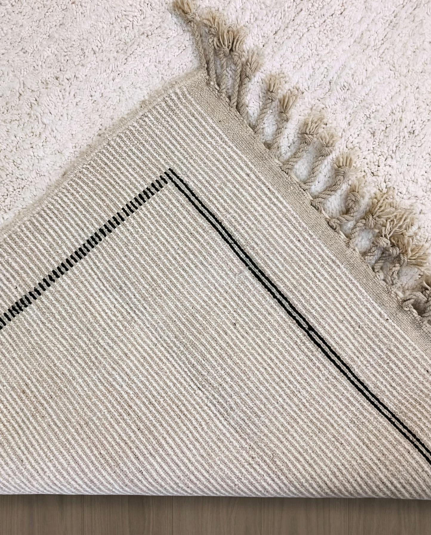 IKRAM Beni Ourain ivory solid border Moroccan rug back view showing traditional handwoven construction, by NURA
