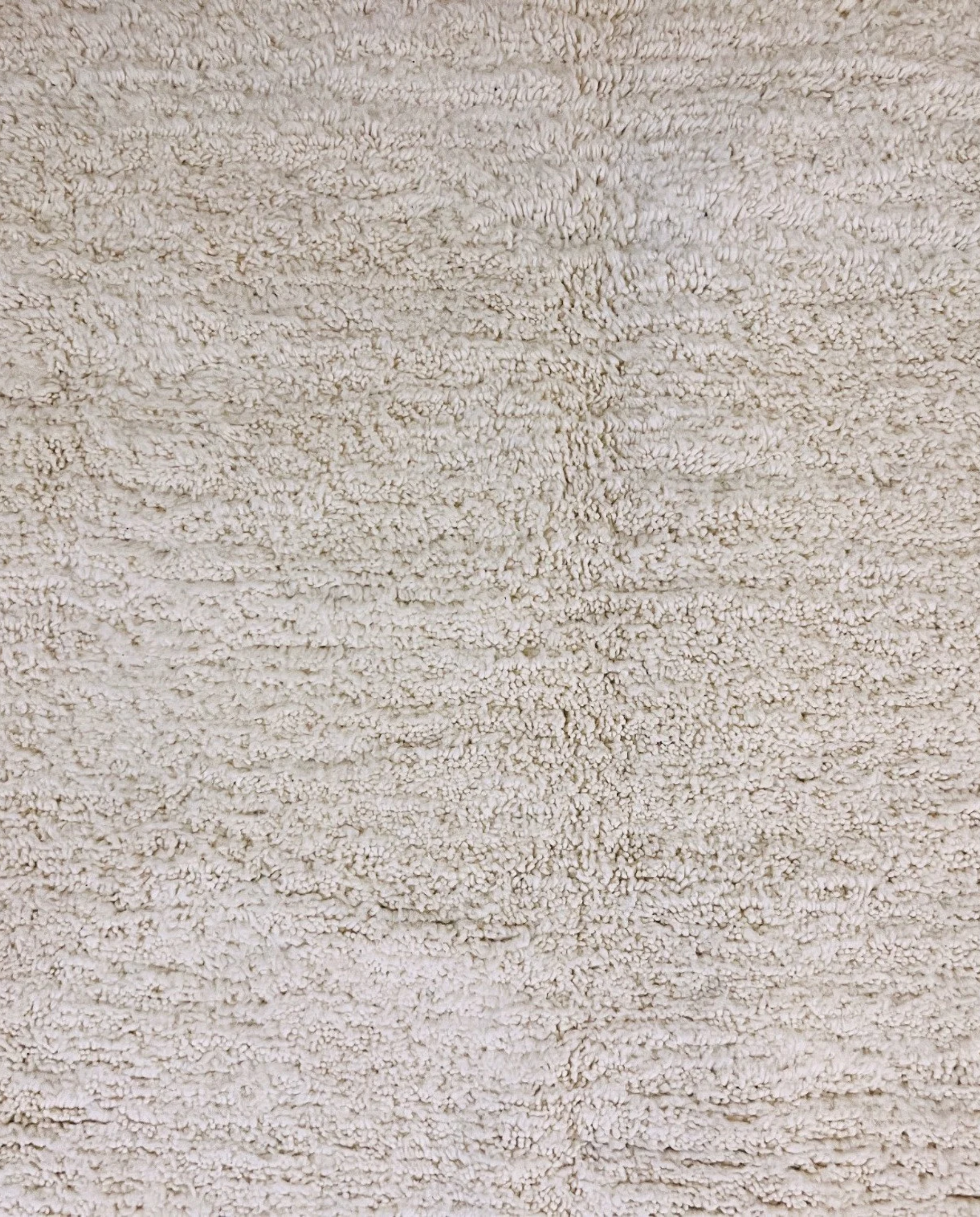 IKRAM Beni Ourain ivory solid border Moroccan rug close-up showing hand-knotted wool texture and pile detail 1, by NURA