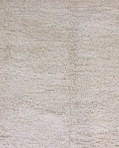 IKRAM Beni Ourain ivory solid border Moroccan rug close-up showing hand-knotted wool texture and pile detail 1, by NURA